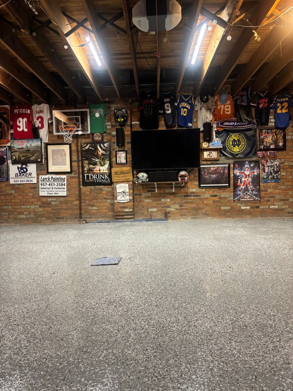 Gray flake epoxy basement floor in a finished basement hangout by SurfaceKings
